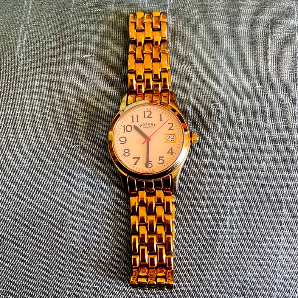 Men’s gold tone, white faced, rotary extender watch.